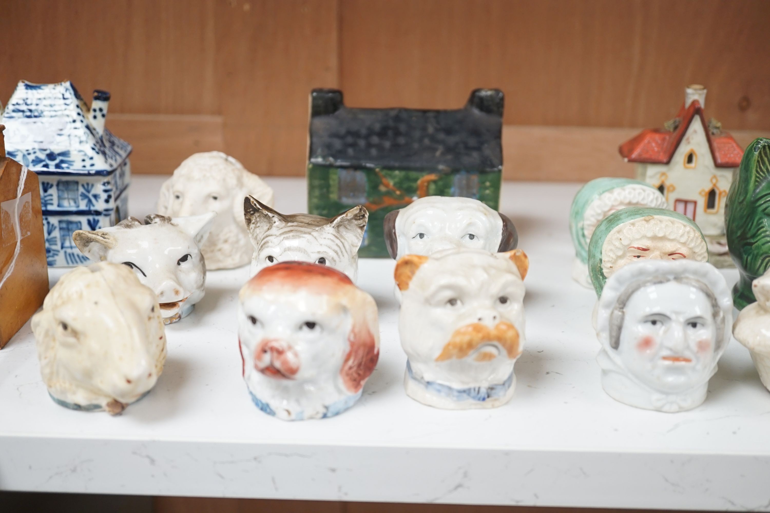 A 19th century Mauchline ware money box, together with fifteen other 19th century ceramic money boxes, Mauchline money box 8.5 cms high.